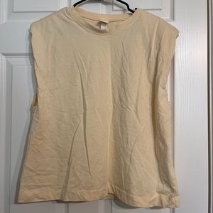 Pale yellow H&M cut off shirt. Size XL, never worn.
